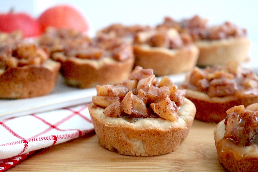 A fantastic fall treat! These Salted Caramel Apple Cookie Cups are made with a soft snickerdoodle cookie base with diced apples and cinnamon with homemade salted caramel sauce drizzled on top.