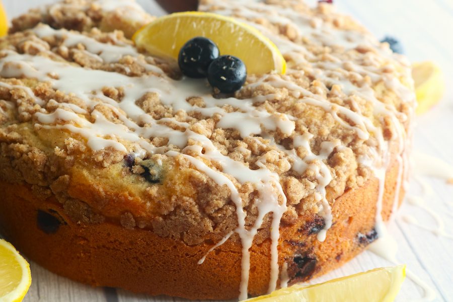 Golden blueberry lemon coffee cake with a tender crumb, bursting with juicy blueberries and bright citrus flavor, topped with a light lemon glaze.