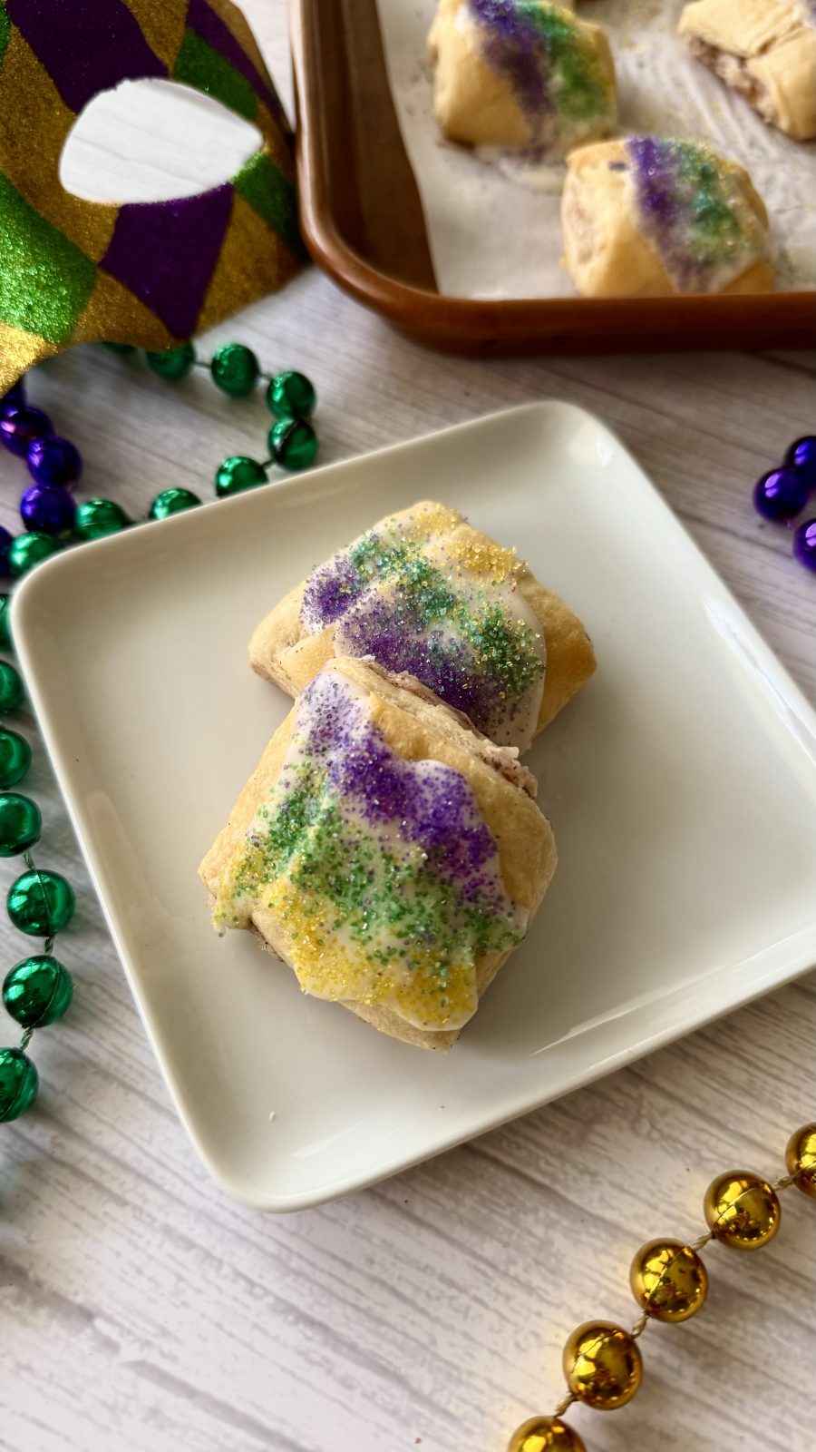 Mardi Gras King Cake bites laying on a pan are a delicious treat for this carnival season.