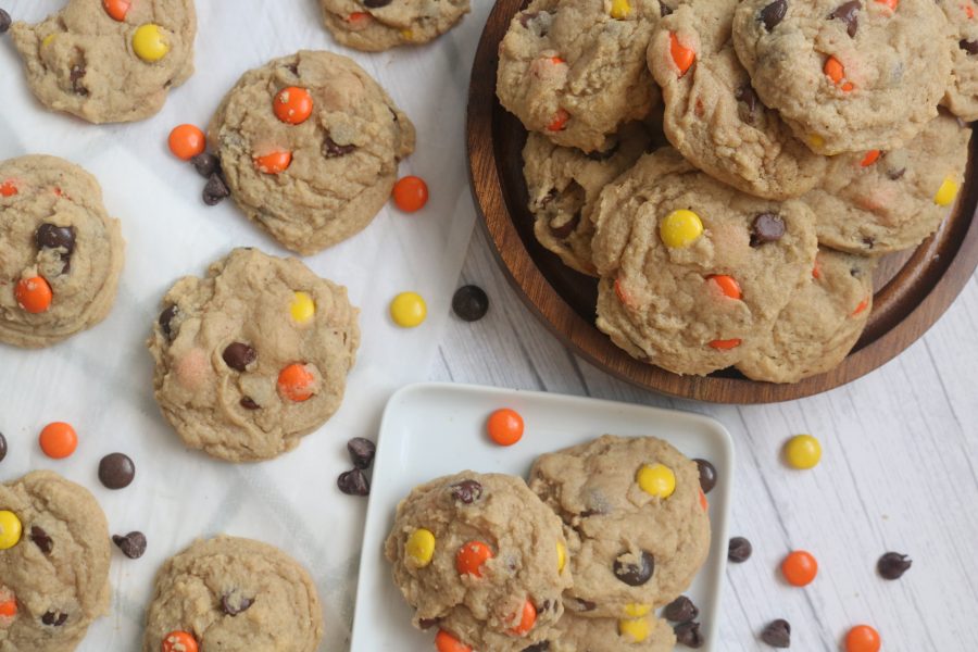 Soft peanut butter candy cookies cooling on parchment paper and a plate